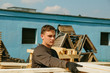 © Dzmitry - Young guy Worker folds boards. Sawmill. Wood harvesting process