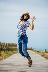 young indian woman jumping in the countryside