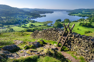 A morning shot of Lake Windermere showing the stone walling and the stile providing passage over the wall. 