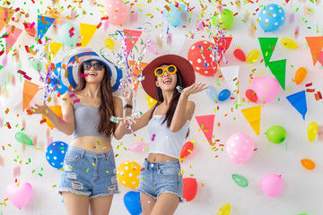 celebration new year or birthday party group of asian young woman and confetti happy,funny concept.drinking wine happy and fun in new year celebrate, color balloon  background.