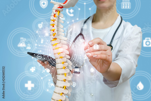Cuadros en Lienzo A doctor with a tablet in her hand is operating with spin model.