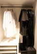 Hangers with black and white clothes in wardrobe closet