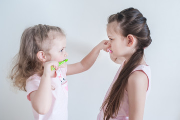 Two Cute pretty little child brushing teeth