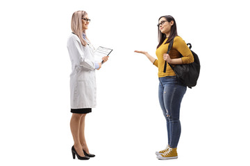 Wall Mural - Female student talking to a young female doctor