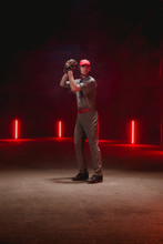 Caucasian Professional Baseball Player Pitcher Posing Against Dark Background