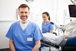 © gpointstudio - Portrait of smiling male dentist in dentist's clinic