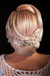 Head of woman iwith hair in weeding bun on black background