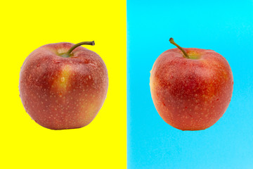 Apple on blue and yellow background. Selective focus