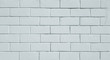 © Payllik - White stone brick textured wall for background.