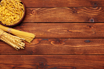 dried pasta on wooden background