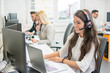 © Bojan - Beautiful young woman with headset using laptop while talking with client. Online customer support.