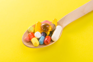 Wall Mural - Pile of colored capsule pills on a spoon