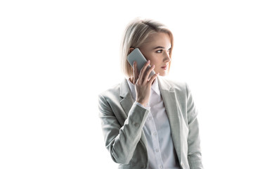 Wall Mural - pretty, confident businesswoman talking on smartphone isolated on white