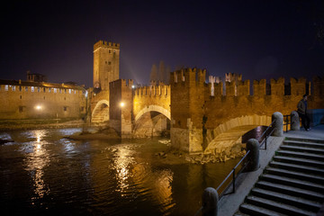 Wall Mural - Verona, Italy – March 2019. Castelvecchio Bridge, Brick & marble bridge with 3 spans & arches, built in the 14th century & reconstructed after WWII. Verona, Italy, Europe