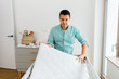 © Syda Productions - parenthood, fatherhood and nursery concept - middle-aged father arranging baby bed with mattress at home
