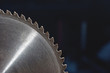 © yanik88 - A closeup of a circular saw blade on a dark blue background. Shop for the production of wooden products. Joiner's cutting tool