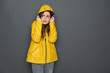 © Yakobchuk Olena - Cropped photo of frustrated Caucasian girl dressed in yellow raincoat in studio
