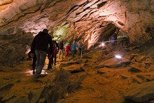 LEVIGLIANI, ITALY - JUNE 05, 2016: Some Visitors Admire The Stalactites Of The Antro Del Monte Corchia Cave In The Apuan Alps In Italy.