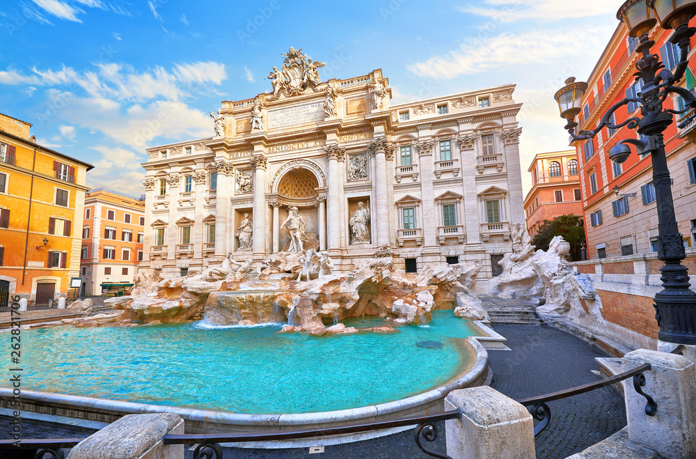 Trevi Fountain in Rome, Italy. Ancient fountain. Roman statues at piazza in old medieval city among traditional italian houses and street lamps. Famous landmark. Touristic destination for vacation. - obrazy, fototapety, plakaty 