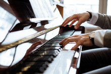 Crop Side View Of Man Hands Playing Piano In A Music Studio