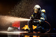 © Fran Rosado/ADDICTIVE STOCK - Anonymous fireman fighting fire with water