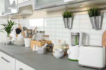 Wall Mural - Different appliances, clean dishes and utensils on kitchen counter