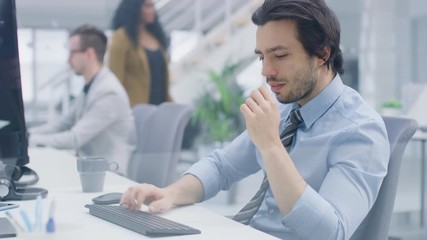 Aufkleber - Portrait of Handsome and Confident Shirt and Tie Wearing Businessman Uses Desktop Computer, Typing on a Keyboard, Monitoring Business Transactions, Signing Contracts. Works in the Big Bright Office