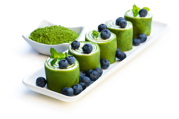 Matcha green tea crepe with whipped cream and blueberry isolated on white