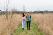 © Jakob Lagerstedt/Stocksy - Cute young couple walking in a field