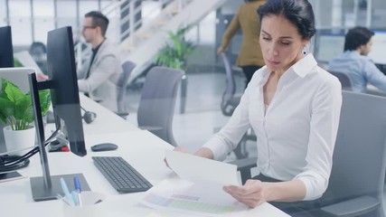 Aufkleber - Beautiful Businesswoman, Economist, Stock Broker Uses Desktop Computer, Typing on a Keyboard, Looking At Sheets, Documents with Graphs and Statistics. in the Background Big Corporate Firm Office