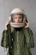 © Danil Nevsky/Stocksy - Young woman wearing old-fashioned spacesuit