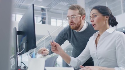 Poster - Beautiful Businesswoman Uses Desktop Computer, Consults Her Project Manager about Documents with Graphs and Statistics. In the Background Big Corporate Firm Office