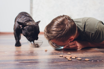 The dog eats the food. the host eats dog food. concept of attracting interest in dry food. pet feeding problem.