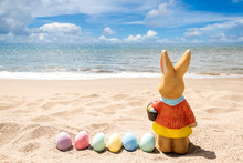 Beach Easter Background With Bunny And Color Eggs