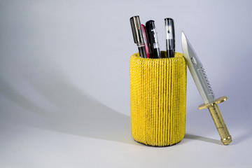 The pen is in the yellow pen stand on white background