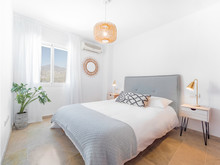Comfortable Hotel Bedroom With Felt Headboard With Natural Fabric Cushion, Rattan Lamp, Wood Nightstand And A Big Wooed Wardrove.Holiday Destination Apartment With Scandinavian Style.