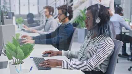 Poster - Team of Handsome and Beautiful Diverse Multicultural Customer Service Operators Working at a Busy Modern Call Center with Specialists Wearing Headsets and Actively Taking Calls. 