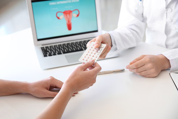 Gynecologist working with patient in office