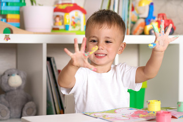 child draws paints fingers