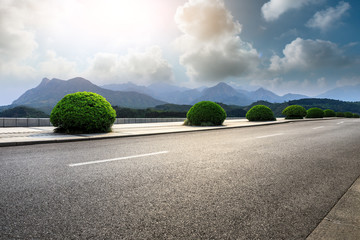 Empty asphalt road and mountains with beautiful clouds landscape