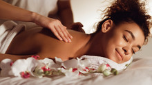 Relaxed Woman Getting Back Massage In Spa Center