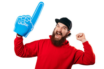 Young bearded manhaving an exciting face with foam blue number one hand on white background.