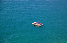 Tiny White Boat With One People In It Alone On A Vast Andaman Sea.