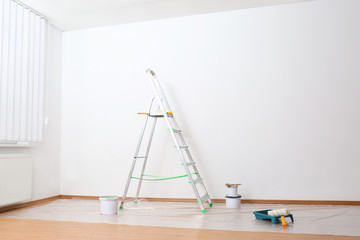 Poster - Stepladder and painting tools near wall in empty room