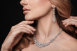 © New Africa - Beautiful young woman with elegant jewelry on dark background, closeup