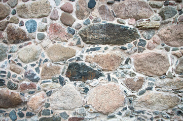 Solid stone wall background. Natural boulder arrangement of different sizes