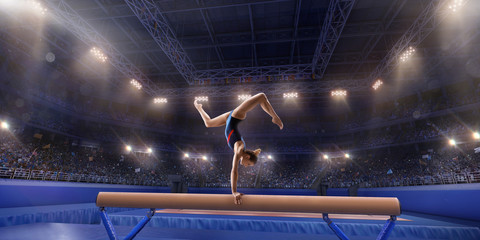 Wall Mural - Female athlete doing a complicated exciting trick on gymnastics balance beam in a professional gym. Girl perform stunt in bright sports clothes