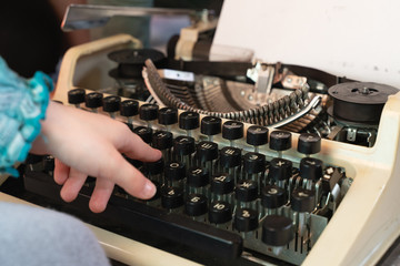 Fototapete - Hands writing on an old typewriter. retro-style. keyboard and font