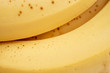 An extreme close-up or macro view of the over-ripe yellow skin of an fresh organic banana fruit.