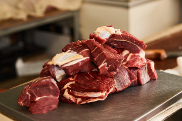 Fresh uncooked sliced meat on scales in meat market  